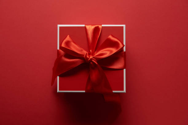 istock top view of present with silk ribbon on red background 1094054972