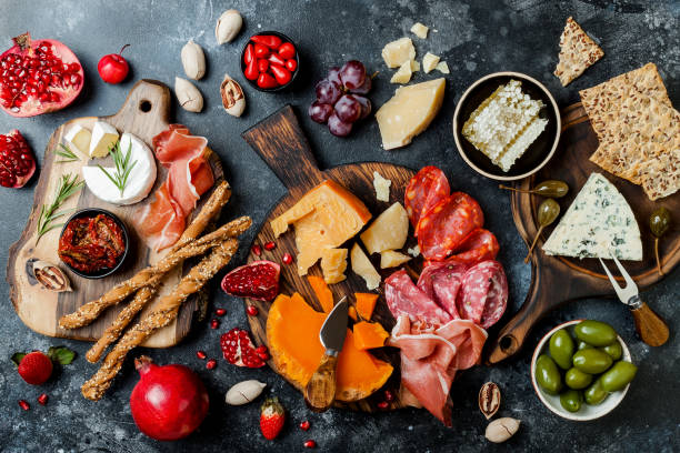 istock Appetizers table with italian antipasti snacks. Brushetta or authentic traditional spanish tapas set, cheese variety board over black stone background. Top view, flat lay 1094054990