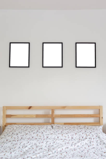 istock Stylish thin black blank frames in bedroom above bed. Modern home decor. Mock up. 1094057970