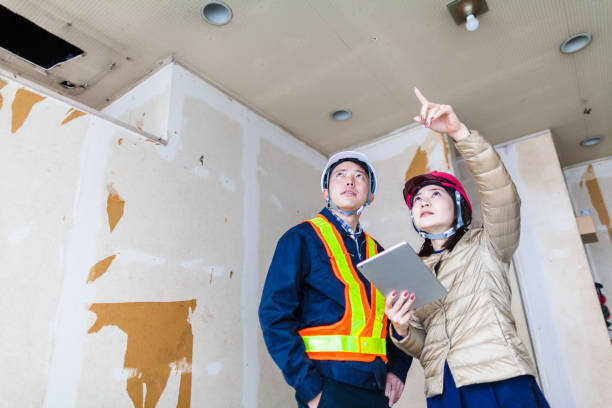 istock Young female building contractor explaining work to male construction worker 1094058770