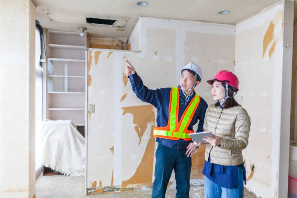 istock Young female building contractor explaining work to male construction worker 1094059138