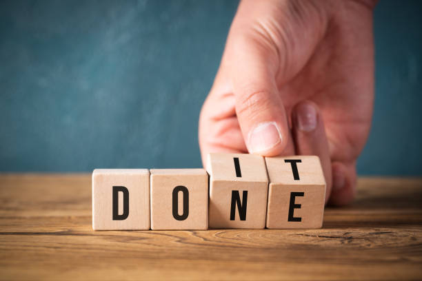 istock hand flips two cubes with letters, changing the word 'do it' into 'done' 1094066976