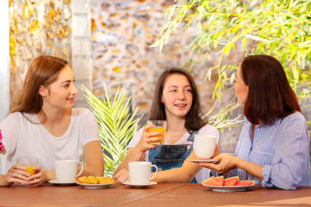 istock Mother and two daughters having breakfast outdoor 1094067586