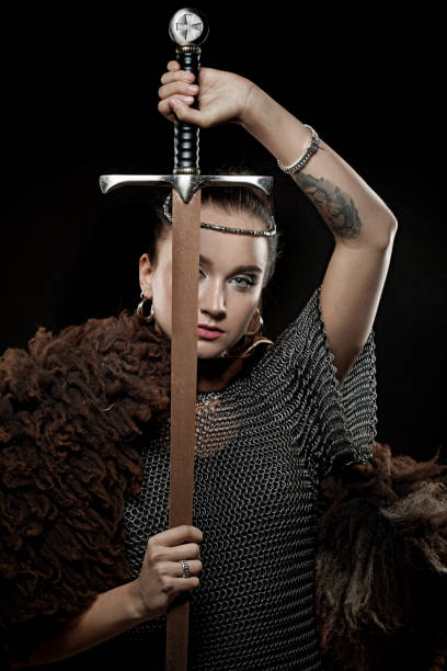 istock Sword wielding viking warrior young blond female in studio shot 1094070708