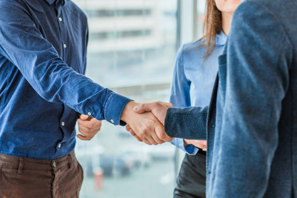 istock Three business people placing a contract put a hand on hand. Showing this obligatory work in the team. 1094081052