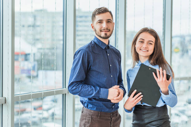 istock The secretary has brought a folder with documents for signature. During this they are all dressed in business clothes. 1094081140