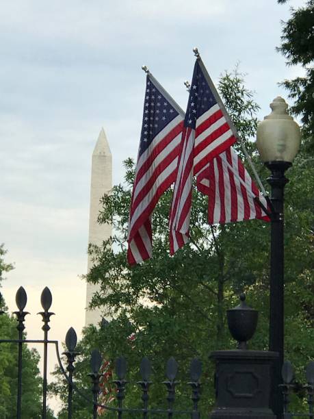 istock Washington National Monument and American Flag 1094086650