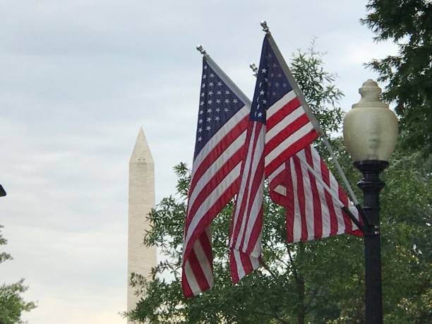 istock Washington National Monument and American Flag 1094086656