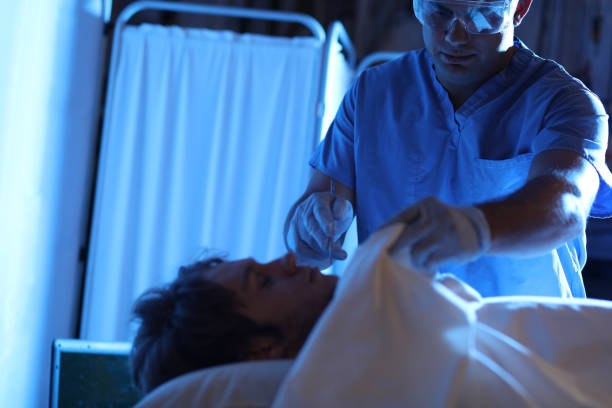 istock Medical Examiner with corpse in morgue. 1094087922