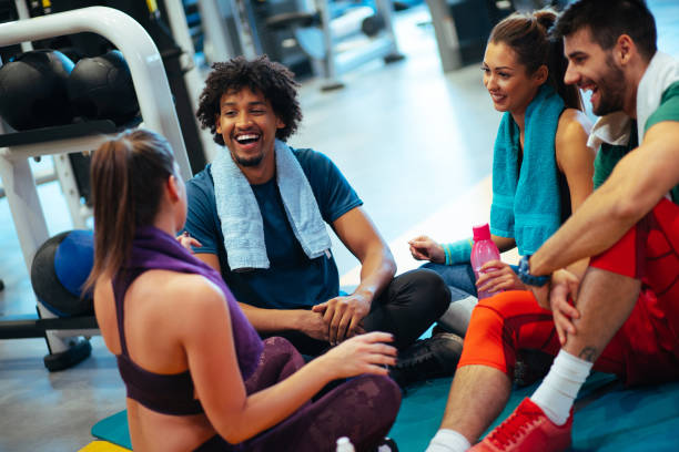 istock Young cheerful people resting from exercising at gym and communicating 1094096268