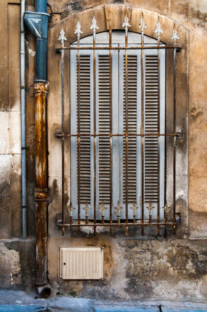 istock light blue louvered shutters and wrought iron 1094100238