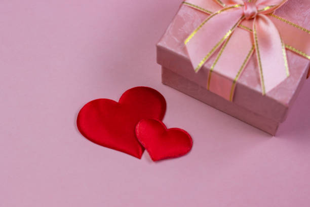 istock A gift in a beautiful box and red hearts on a pink background. Valentine's Day, International Women's Day. 1094101818