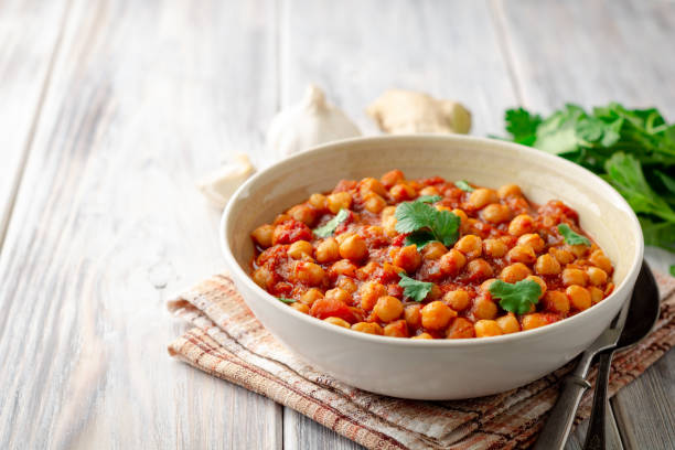 istock Spicy Chickpea curry Chana Masala in bowl on wooden table 1094101994