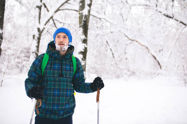 istock Man Traveler walking alone snow mountains. 1094103512