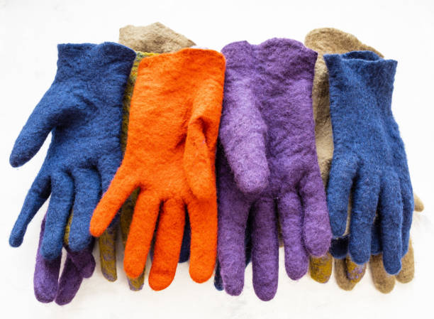 istock heap from new felted gloves on gray 1094103688