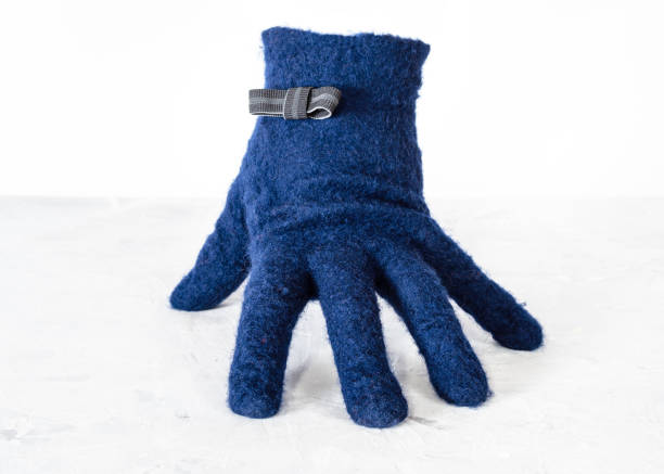istock blue woolen glove with bow tie stands on board 1094103736