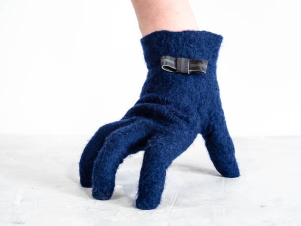 istock hand in glove with bow tie leans on gray board 1094103752