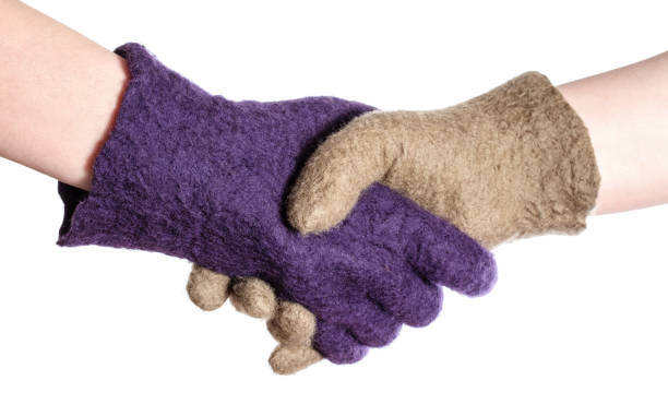 istock handshake of hands in colour woolen gloves 1094103756