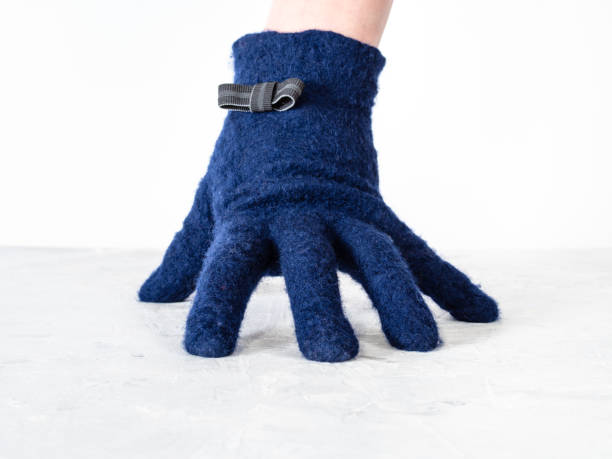 istock hand in glove with bow tie leans on gray board 1094103758