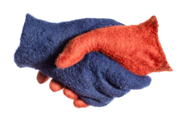 istock handshake of blue and orange gloves isolated 1094103776
