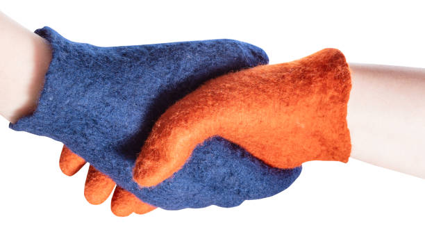 istock handshake of blue and orange gloved hands 1094103778