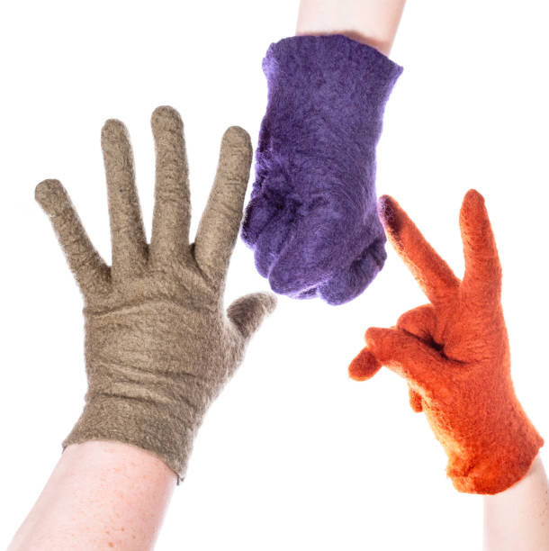 istock hands in woolen gloves show rock-paper-scissors 1094103788