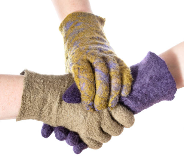 istock hand fastens handshake of hands in colored gloves 1094103832