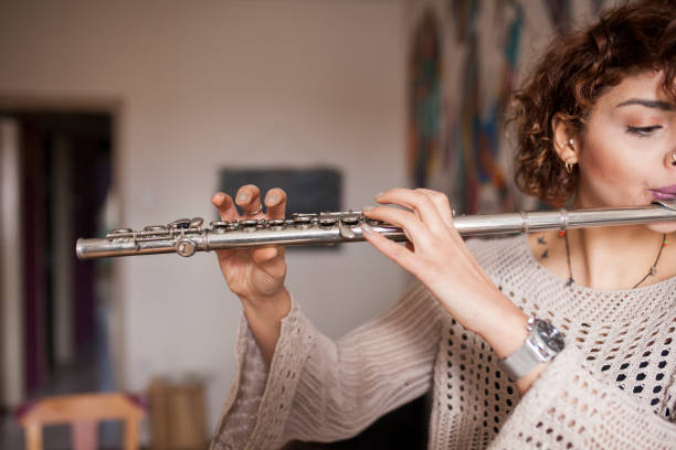 istock Woman playing silver hole c flute 1094103876