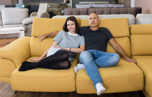 istock Couple sitting on yellow sofa 1094105638
