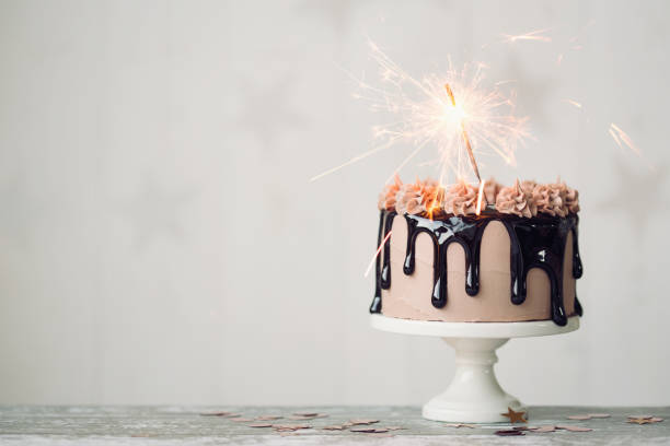 Chocolate birthday cake Chocolate drip cake with sparkler for a birthday or celebration birthday cake photos stock pictures, royalty-free photos & images
