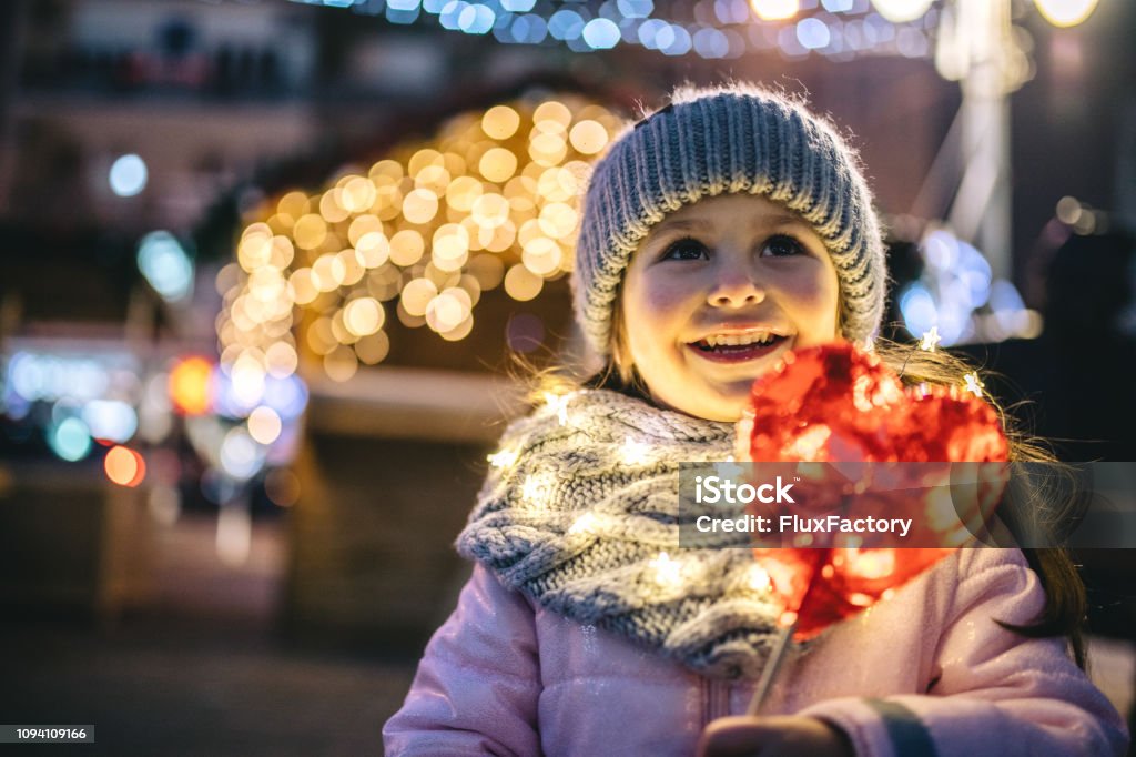 I love candy! Carefree cute little four year old girl enjoying the new year and christmas holidays Christmas Stock Photo