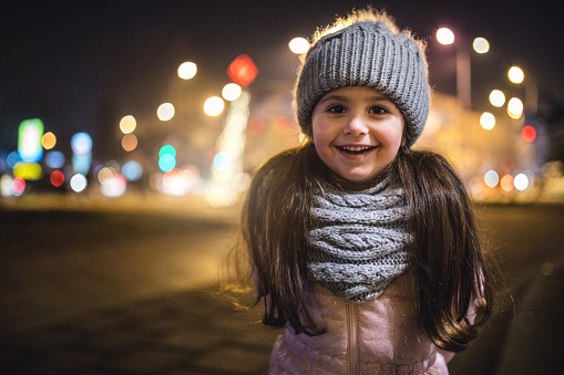 Carefree cute little four year old girl enjoying the new year and christmas holidays