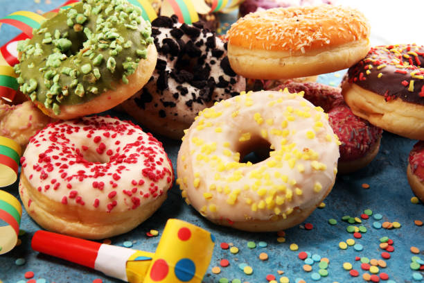istock assorted donuts with chocolate frosted, pink glazed and sprinkles donuts 1094117544