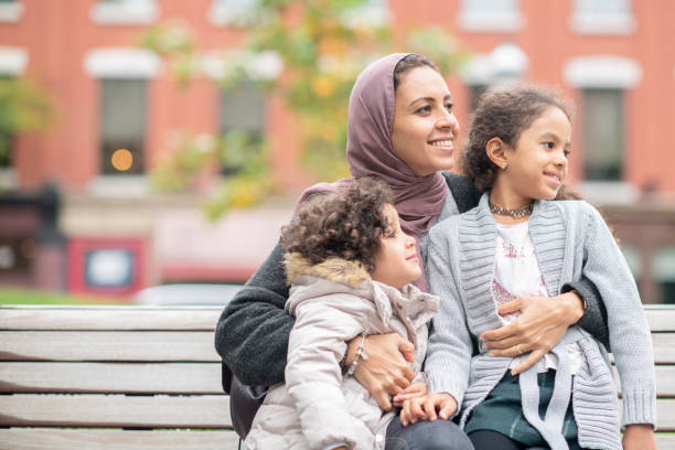 istock Mother smiling holding her children 1094120258