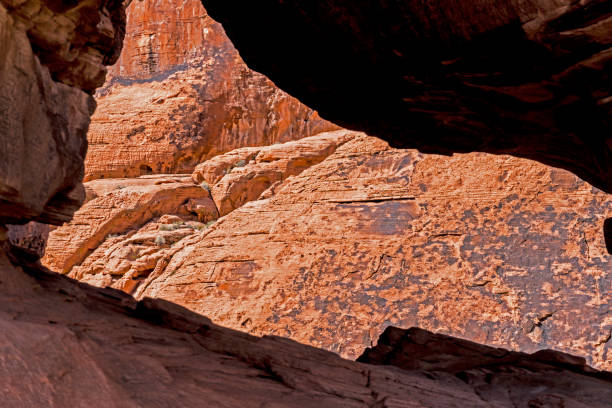 istock Abstract-a split in a rock picks up sun shining, lighting a boulder. 1094120518