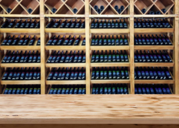 Wood table with blured background wine bar, for your photo montage or product display. Space for placing items on the table. Wooden table with blured background wine bar, for your photo montage or product display. Space for placing items on the table. Front view. wine bar counter stock pictures, royalty-free photos & images