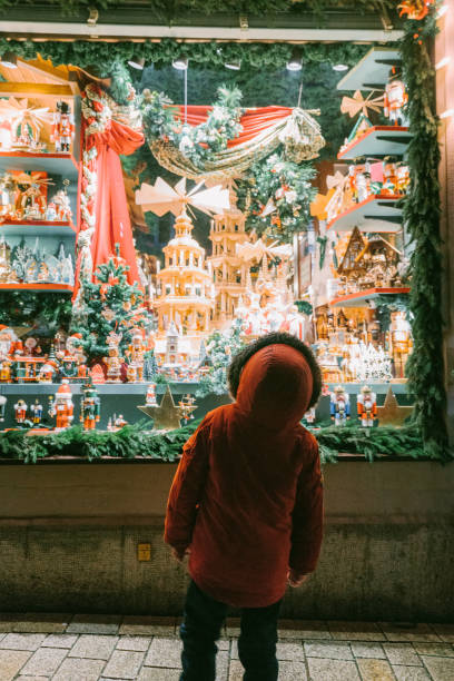 Little boy looking at store window on Christmas