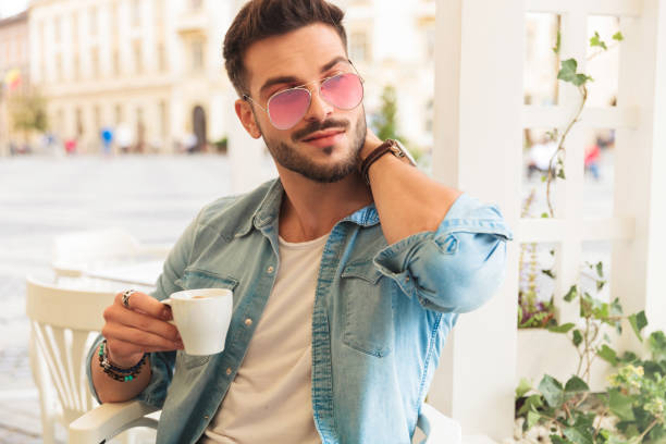 istock relaxed man drinking coffee and touching neck looks to side 1094127768