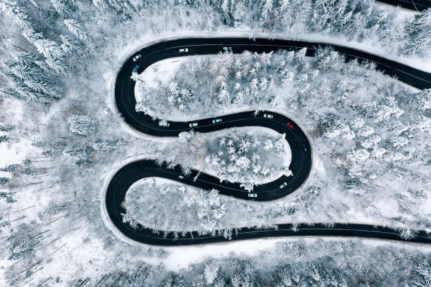 istock Winter driving conditions on winding road trough a mountain pass 1094128428