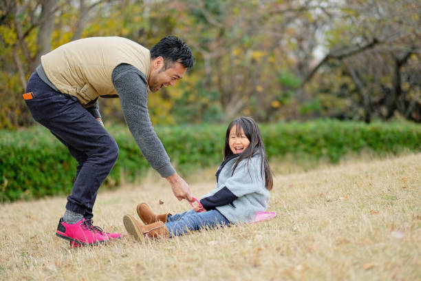 istock Father and daughter playing in park 1094128932