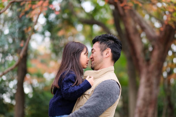 istock Father embracing daughter in park 1094129564