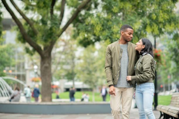 istock Girlfriend and boyfriend walking through a park 1094130016