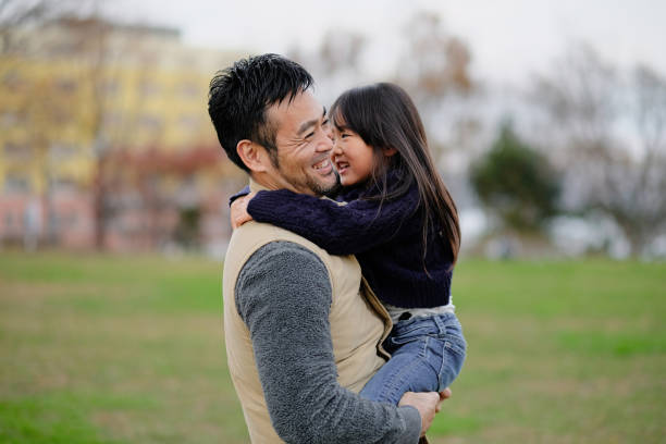 istock Father embracing daughter in park 1094130178