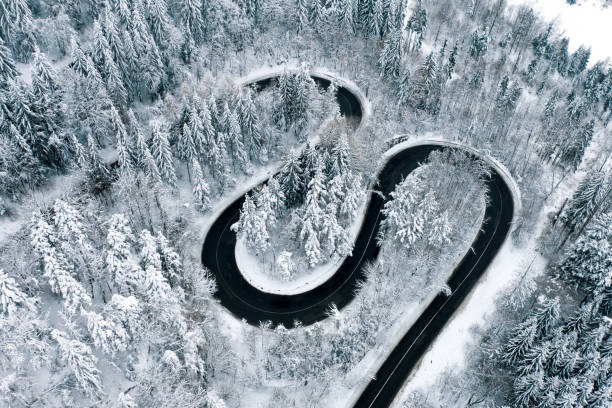 istock Winter highway trough a forest aerial view 1094130352