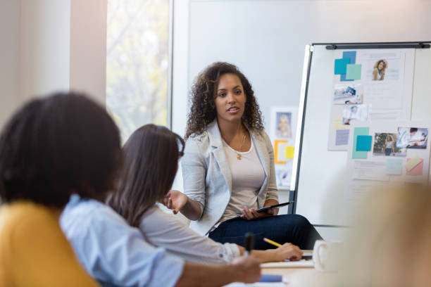istock Business manager speaks to employees in conference room 1094130500