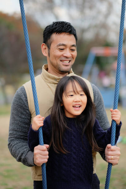istock Father playing with playground equipment in park 1094131964
