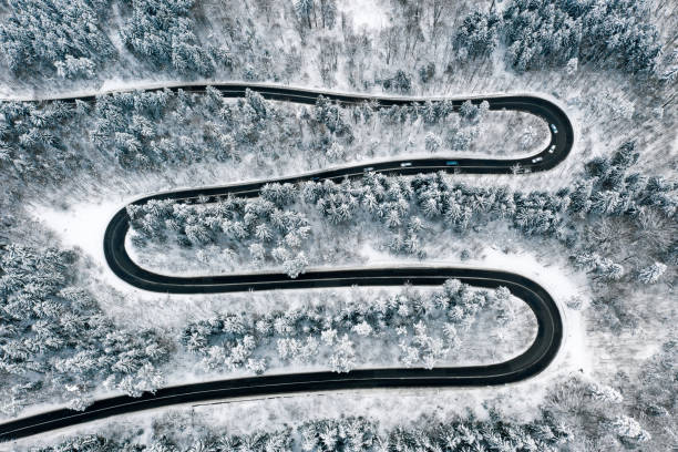 istock Winter winding road in the forest aerial view 1094132124