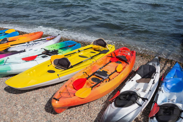 istock many colored kayaks stand in a row on the beach, concept 1094132558