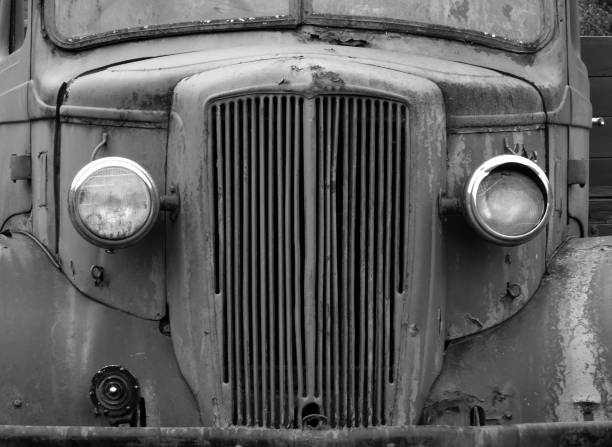 monochrome front view of an old abandoned rusty 1940s truck a monochrome front view of an old abandoned rusty 1940s truck distressed rusty vintage pickup truck close up detail stock pictures, royalty-free photos & images