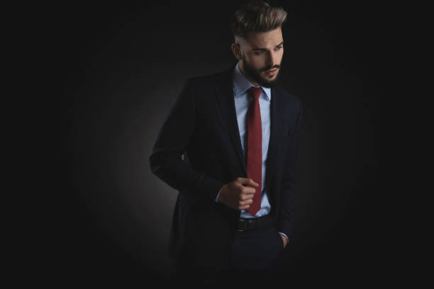 istock seductive man holding pockets looks down to side 1094134224